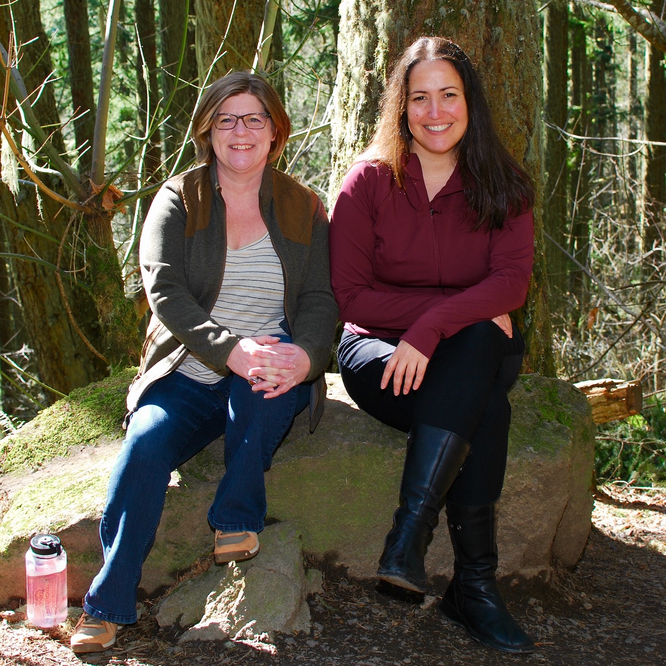 Tenaya and Alex sitting on a rock during a hike